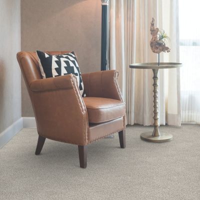 carpet in a living room with a leather chair and side table